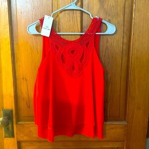 Red blouse with lace and crochet appliqué